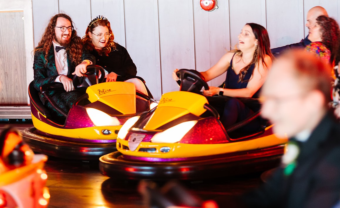 Wedding couple have fun on rides - Clacton Pier